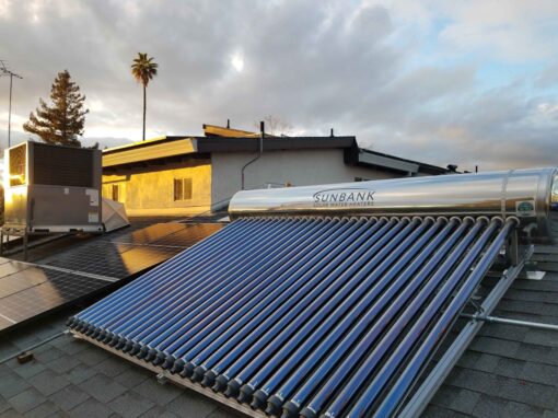 Photo of a Sunbank 80 gallon system flush mounted on a comp shingle roof at sunset
